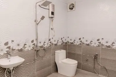 a bathroom with a shower and a toilet and a sink at As Sufi Villa in Kampung Sungai Air Tawar