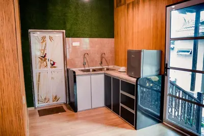 a small kitchen with a sink and a refrigerator at As Sufi Villa in Kampung Sungai Air Tawar