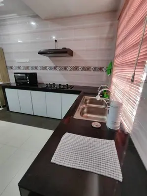 a kitchen with a sink and a counter top at Ipoh Cozy Premium Spacious Home in Ipoh