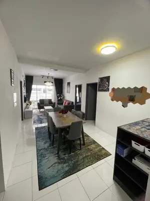 a dining room and living room with a table and chairs at Amy Homestay in Brinchang