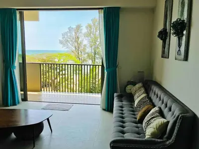 a living room with a couch and a large window at 5 Stars Seafront Suite By The Sea \u65e5\u843d\u65e0\u654c\u5168\u6d77\u666f 5\u661f \u9152\u5e97\u7b49\u7ea7 in Batu Ferringhi