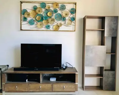a living room with a television and a painting on the wall at 5 Stars Seafront Suite By The Sea \u65e5\u843d\u65e0\u654c\u5168\u6d77\u666f 5\u661f \u9152\u5e97\u7b49\u7ea7 in Batu Ferringhi