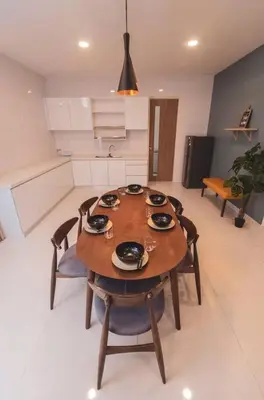 a wooden table in a kitchen with chairs at Luxury 3-sty semi-D 5BR 5Bath@Batu Ferringhi 15ppl in Batu Ferringhi