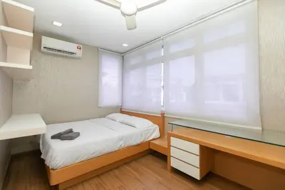 a bedroom with a bed and a desk and a window at GeorgeTown PrivatePool Snooker 25Pax BBQ in George Town