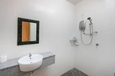 a white bathroom with a sink and a mirror at Penang Balik Pulau Swimming Pool BBQ KTV Homestay in Balik Pulau