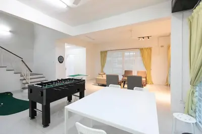 a living room with a table and a piano at Penang Balik Pulau Swimming Pool BBQ KTV Homestay in Balik Pulau