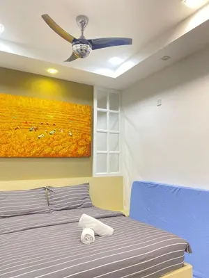 a bedroom with a blue bed with a ceiling fan at Lovely Cozy studio 3pax@mansion one Gurney in George Town