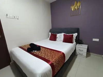 a bedroom with a large bed with red pillows at L Ferringhi Hotel in Batu Ferringhi