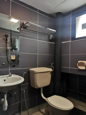 a bathroom with a toilet and a sink at Sabai Sabai Guesthouse in Bayan Lepas in Bayan Lepas