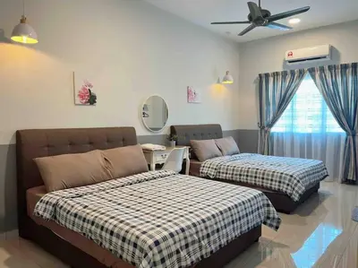 a bedroom with two beds and a ceiling fan at Sweet HOME FOR BIG Family\uff5c11pax+FREE WIFI in Sitiawan