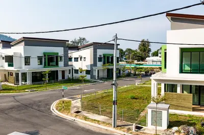 an empty street in a town with houses at HyperTribe -Pangkor Holiday Home in Kampong Sungai Udang