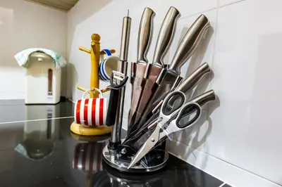 a bunch of kitchen utensils in a holder on a counter at HyperTribe -Pangkor Holiday Home in Kampong Sungai Udang
