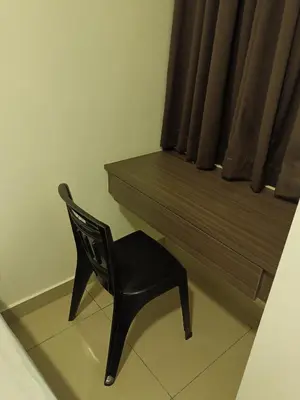 a black chair sitting next to a window with a bench at Cold house in Cameron Highlands