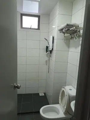 a small bathroom with a toilet and a window at Cold house in Cameron Highlands