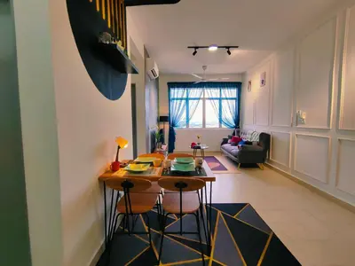 a kitchen and living room with a table and chairs at Desig Classic Falim by irainbow in Ipoh
