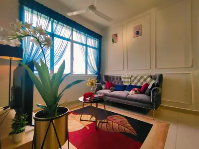 a living room with a couch and a plant at Desig Classic Falim by irainbow in Ipoh