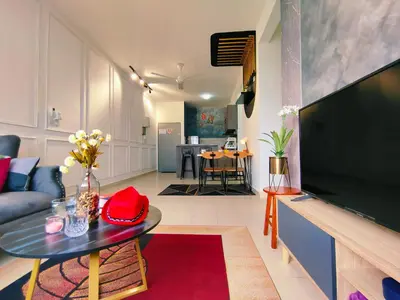 a living room with a large flat screen tv at Desig Classic Falim by irainbow in Ipoh