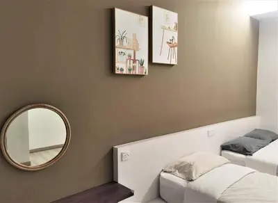 a room with a mirror and a bed and a mirrorphasis at Emerald Avenue Cozy 3R3B Apartment 715 in Brinchang