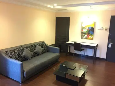 a living room with a couch and a piano at Legend Inn Taiping in Taiping
