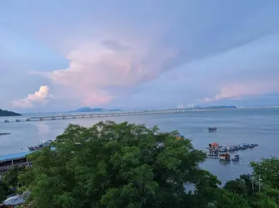 a bridge over a large body of water with boats at Southbay Seaview Condo A10 #10minQueensbay #15minSPICE in Bayan Lepas