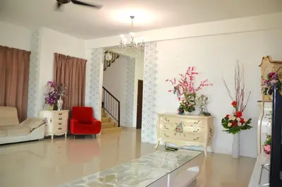 a living room with a red chair and two tables at Near Gurney 3-Storey Event Hse by Felice Homestay in Tanjong Tokong