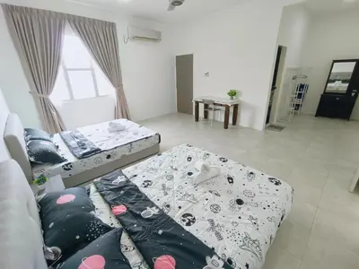 a living room with two beds and a window at Yarra Park, Up to 10 Pax, 5 Bedrooms, 4 Bathrooms, 2 Car Parks by Star Home in Sungai Petani
