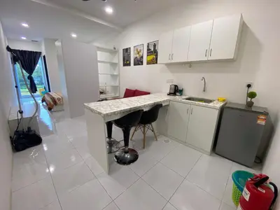 a kitchen with a counter and two stools at Jom singgah in Seri Iskandar