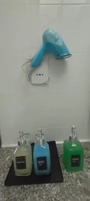 a pair of batteries and a blow dryer on a counter at Seaview Deluxe Rainbow Paradise Tg Bungah 6pax in Tanjung Bungah