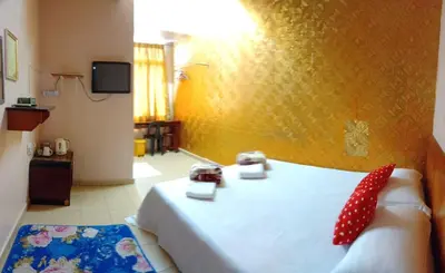 a bedroom with a bed with two phones on it at Hotel Muallim Tanjung Malim in Tanjung Malim