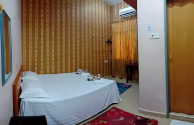 a room with a white table with cups on it at Hotel Muallim Tanjung Malim in Tanjung Malim