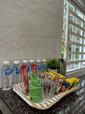 a tray with bottles of water and drinks on a counter at DeAsmarra Homestay in Tanjung Piandang