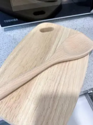 a wooden cutting board sitting on top of a counter at TheSun #Studio #BayanLepas #Pisa in Kampong Manggis