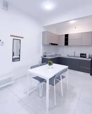a white table and chairs in a white kitchen at TheSun #Studio #BayanLepas #Pisa in Kampong Manggis