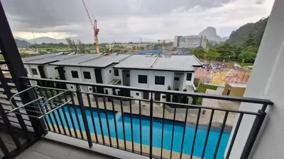 a balcony with a view of a building and a pool at H&W Sunway Onsen Suites Services Tambun Ipoh S-07-05 in Ipoh