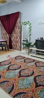 a large rug on the floor in a living room at D'HutHomestay Puncak Iskandar in Seri Iskandar