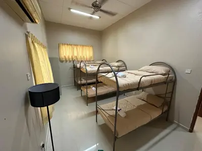 a room with four bunk beds in a room at GS HOMESTAY WHOLE VILLA in Bayan Lepas