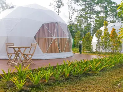 a tent with chairs and a table in a yard at The Dome @ Gua Musang in Gua Musang