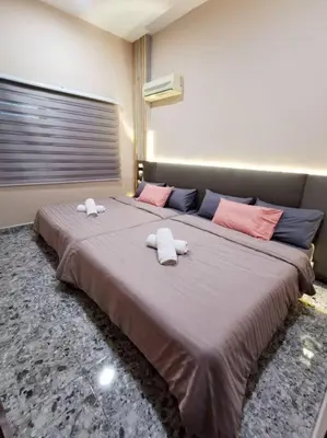 a bedroom with two beds with towels on them at English comfort house in ipoh by SuccessWisdom\u5ea6\u5047\u667a\u5bcc in Ipoh