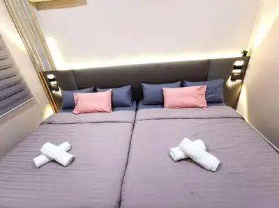 a bedroom with two beds with pillows on them at English comfort house in ipoh by SuccessWisdom\u5ea6\u5047\u667a\u5bcc in Ipoh