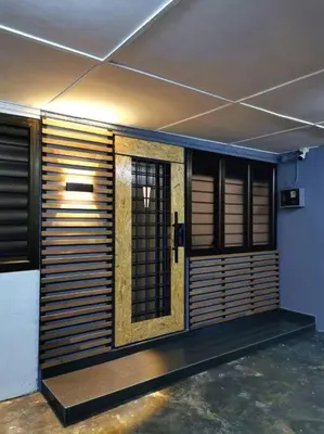 a room with wooden doors and windows in a building at English comfort house in ipoh by SuccessWisdom\u5ea6\u5047\u667a\u5bcc in Ipoh