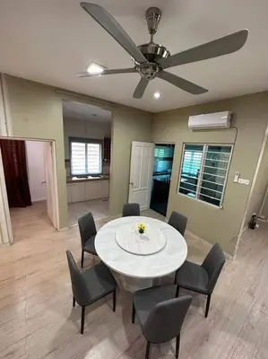 a dining room with a table and chairs and a ceiling fan at Ipoh Luxury Spacious Corner Home in Ipoh