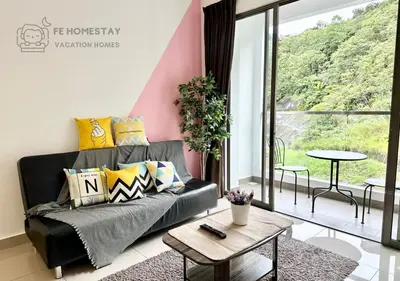 a living room with a black couch and a table at FE Cozy Cameron Homestay Family 8 pax 3BR Palas Horizon Brinchang \u91d1\u9a6c\u4f26\u6c11\u5bbf 8\u4eba3\u623f in Brinchang