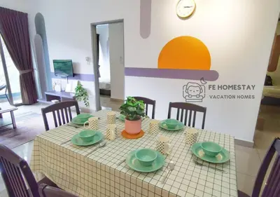 a table with green dishes on it in a room at FE Cozy Cameron Homestay Family 8 pax 3BR Palas Horizon Brinchang \u91d1\u9a6c\u4f26\u6c11\u5bbf 8\u4eba3\u623f in Brinchang