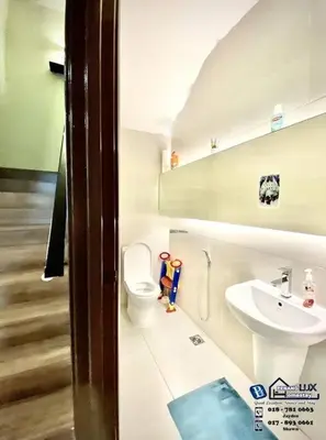 a bathroom with a toilet and a sink at Batu Ferringhi Luxurious Modern Designed 5BR House in Batu Ferringhi