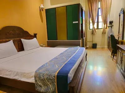 a bedroom with a large bed in a room at The Century Hotel George Town \u4e54\u6cbb\u5e02\u4e16\u7eaa\u9152\u5e97 in George Town