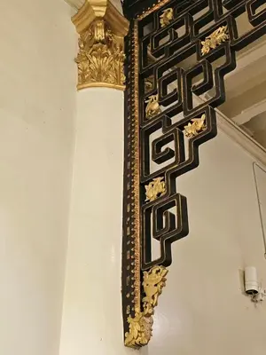 a gold and black ornate mirror on a wall at The Century Hotel George Town \u4e54\u6cbb\u5e02\u4e16\u7eaa\u9152\u5e97 in George Town