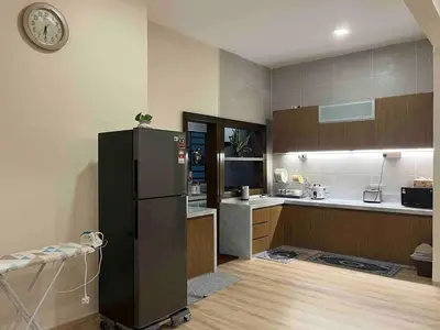 a kitchen with a black refrigerator in a room at Lucky Home @ Quintet Tanah Rata in Cameron Highlands