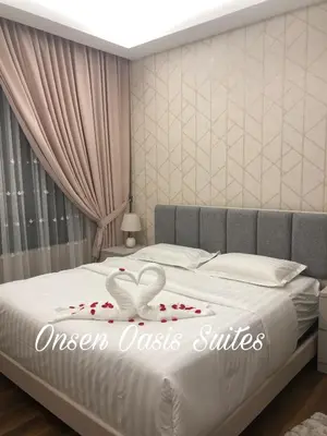 a bedroom with a bed with roses on it at Onsen Oasis Premium Suites in Tambun
