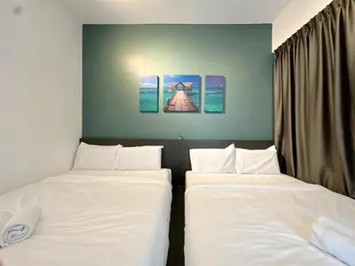 two beds in a room with white sheets at Ipoh Town - Majestic Cozy Deluxe Homestay in Ipoh