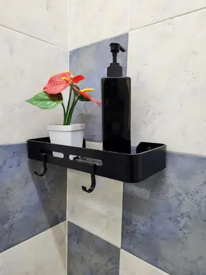 a black shelf with a flower in a pot on a wall at Galaxy Guest Home by Ipoh Maju Stay in Ipoh